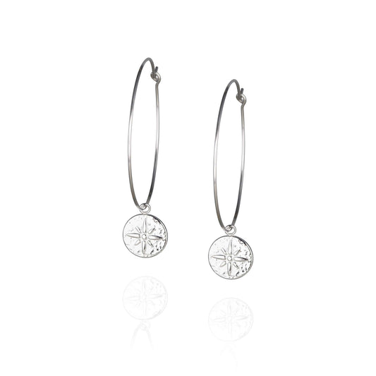 Pair of large, thin silver hoop earrings with round embossed pendant with star detail