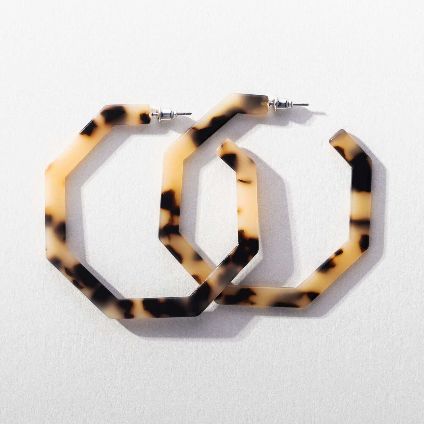 Pair of ivory and brown coloured hexagon shaped hoop pierced earrings