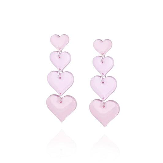 Pair of statement drop pendant earrings featuring four pink hearts increasing in size