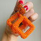 Orange beaded statement earrings