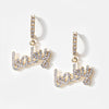 Pair of small pierced huggie hoop crystal earrings with a baby word pendant 