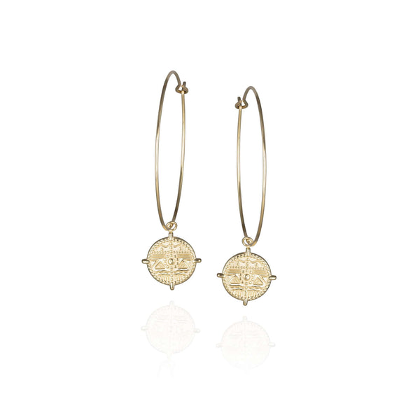 Pair of large, thin golden hoop earrings with round embossed pendant 