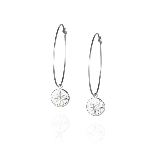 Pair of large, thin silver hoop earrings with round embossed pendant with star detail
