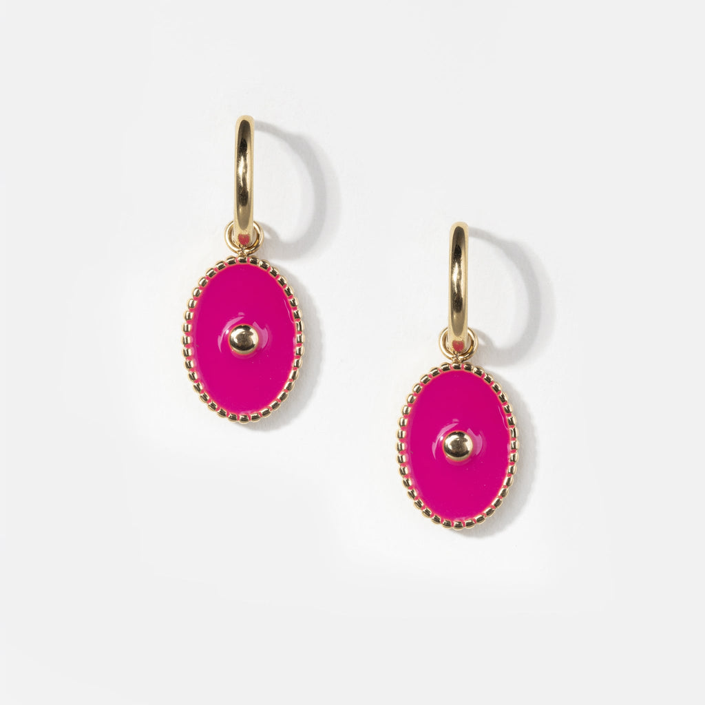 Pair of small gold pierced hoop huggie earrings with hot pink pendant