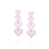 Pair of statement drop pendant earrings featuring four pink hearts increasing in size 