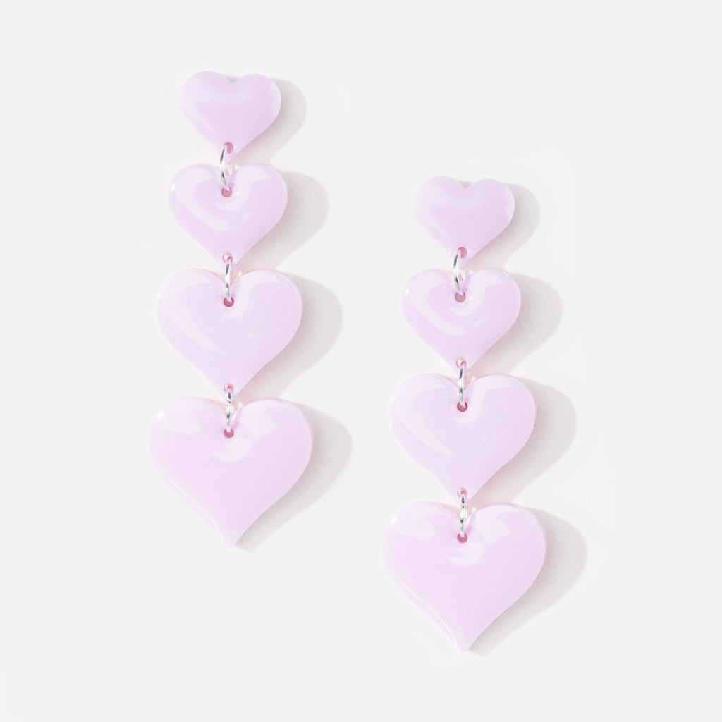 Pair of statement drop pendant earrings featuring four pink hearts increasing in size